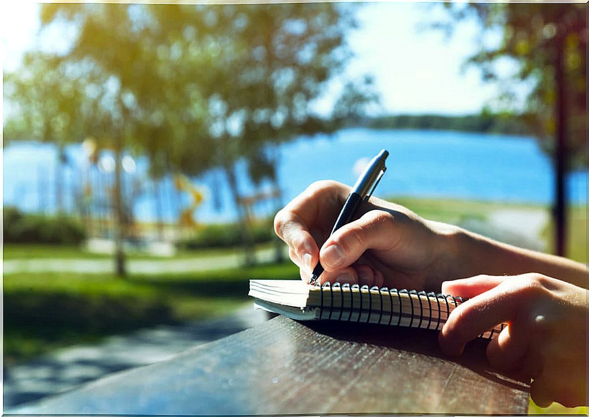 Woman writing outdoors