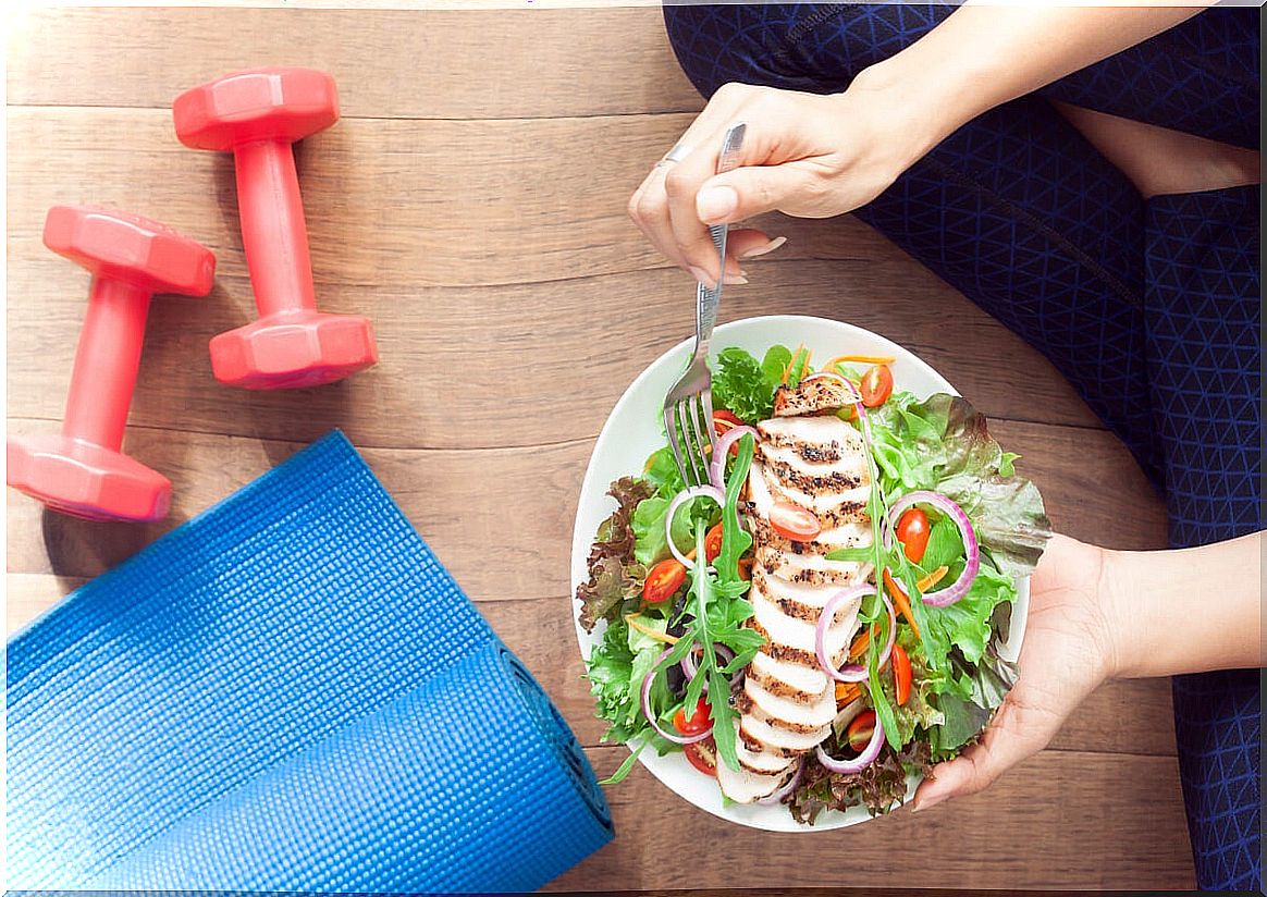 Woman eating salad after exercising