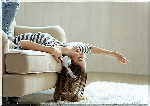 Woman listening to music on sofa