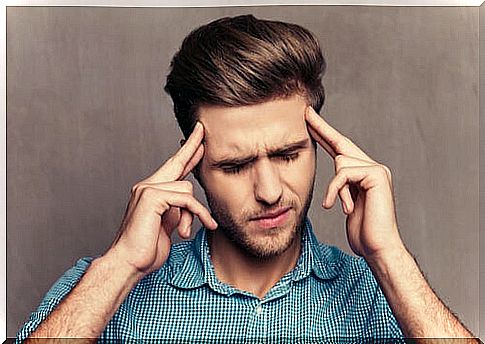 Man feeling grudge with hands on head