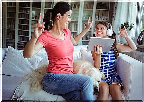 Mother and daughter dancing and listening to music