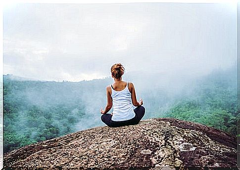 Woman meditating on a mountain