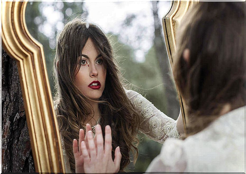 Woman looking in a mirror looking for another personality