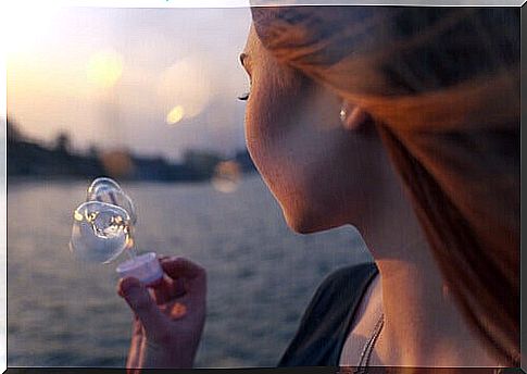 Woman blowing bubbles feeling homesick