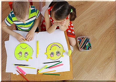Children drawing emotion faces for emotional literacy