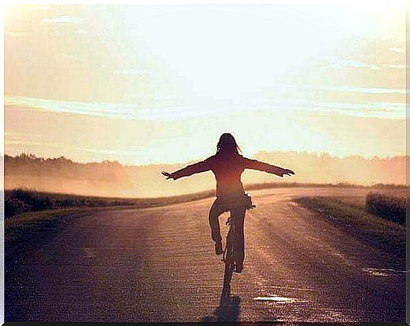 Woman enjoying her happiness on a bicycle