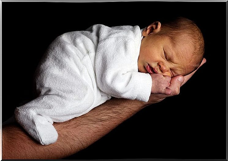 Baby asleep on one arm