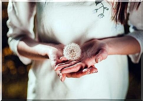 Woman with a dandelion in her hands