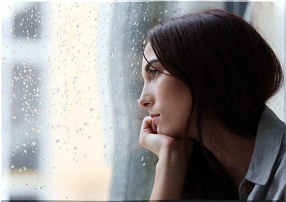 Sad woman looking out the window