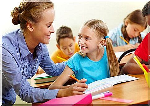 Teacher helping her students