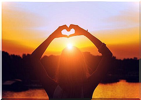 Woman making a heart with her hands while thinking "I'm going to give myself a chance"