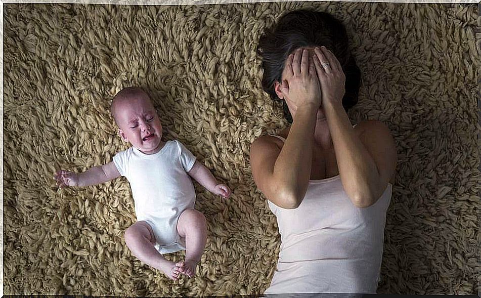 Mother crying with her son beside