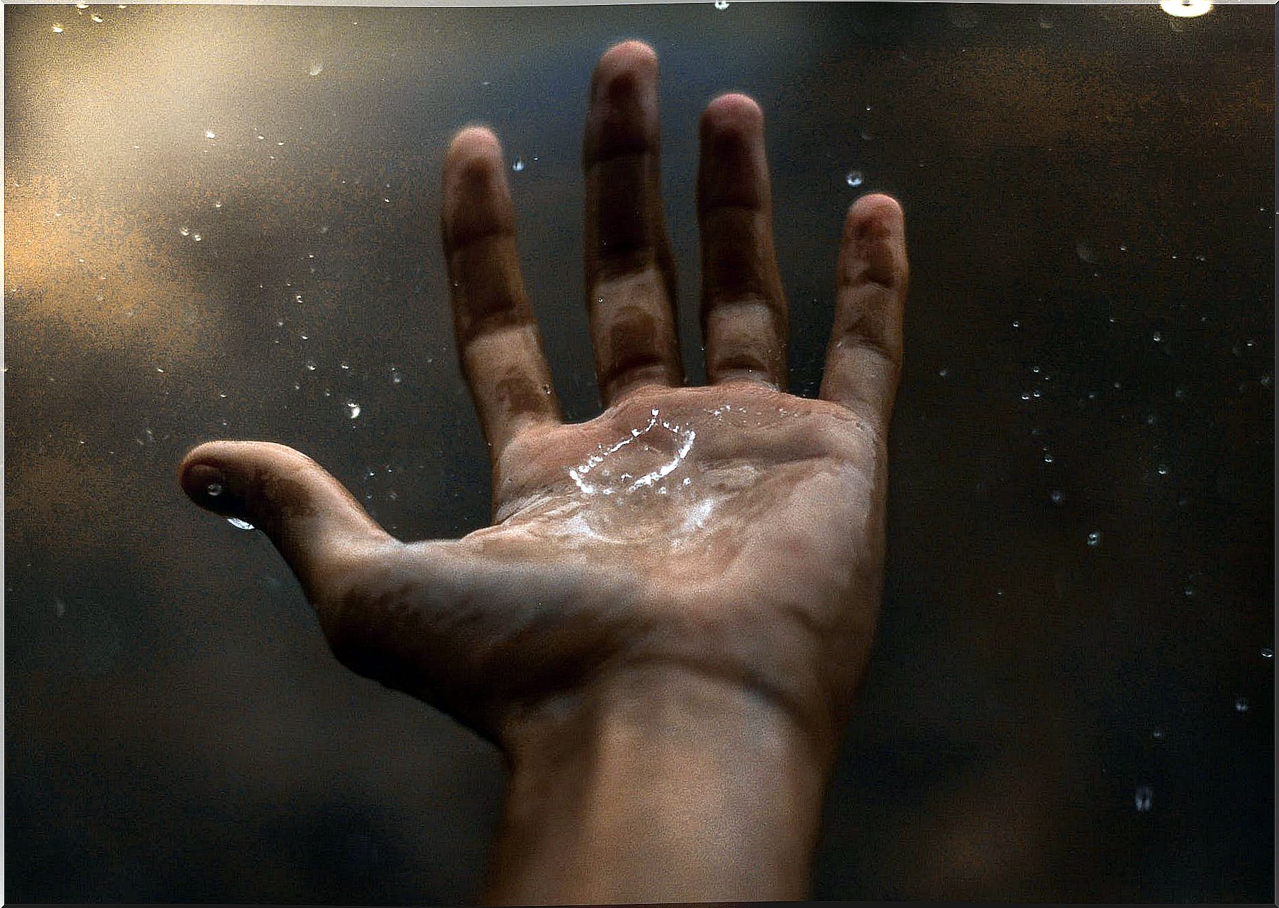 Hand with rain representing accepting the unforeseen