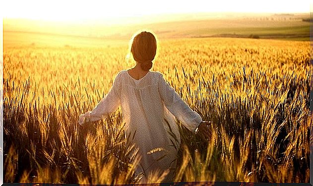 woman walking through the field after ending a relationship