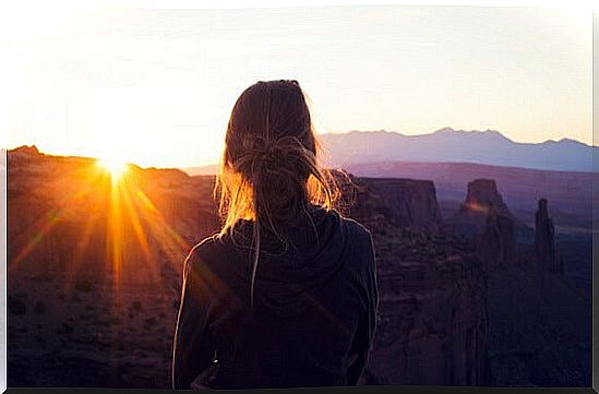 Girl from behind looking at landscape suffering Introversion with high functioning anxiety