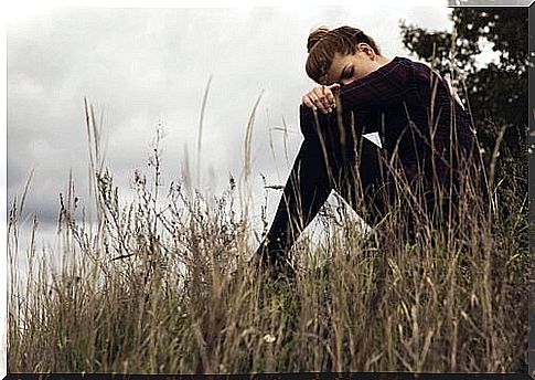 Woman sitting sad and afraid