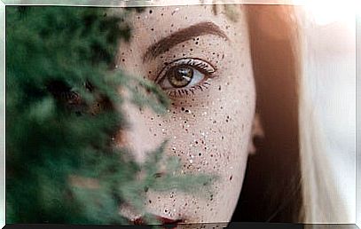 woman behind tree branch representing strong character and resilience