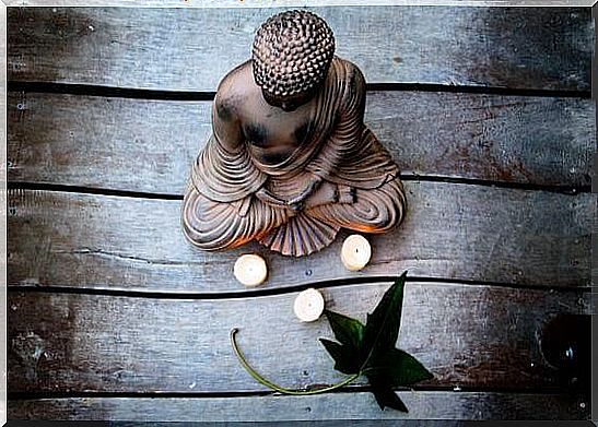 Buddha statue with three candles