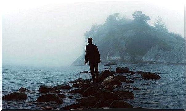 boy on rocks on a beach representing a sensitive person