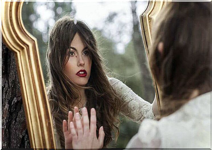 Woman afraid of loneliness looking in a mirror