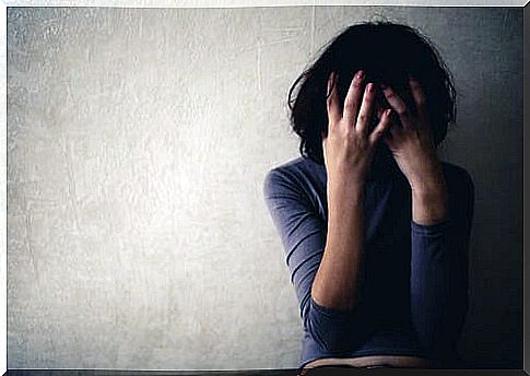 Woman with double depression covering her face