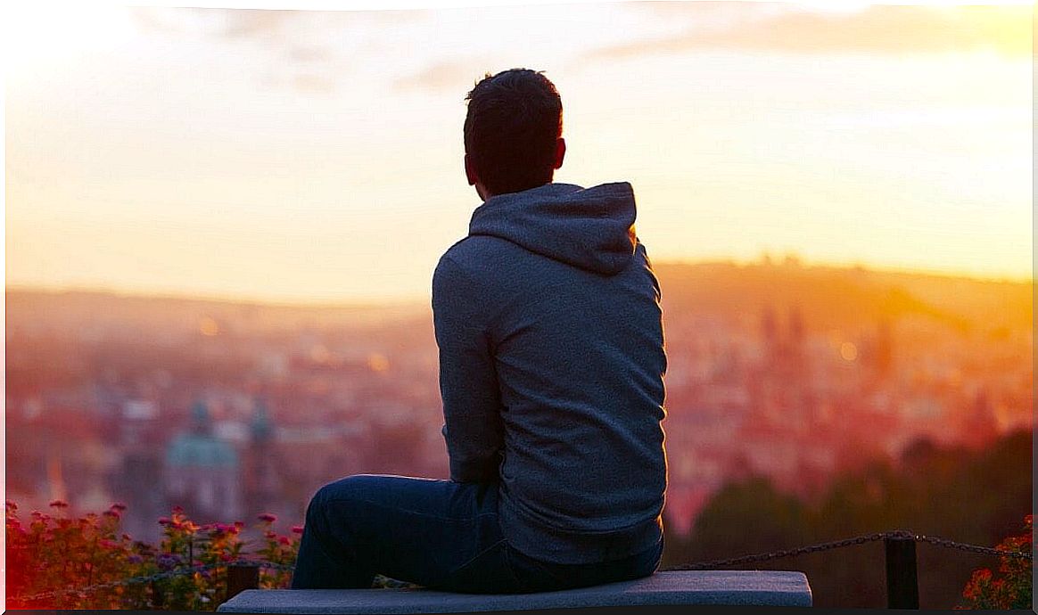 Young man looking at the horizon thinking about his problems