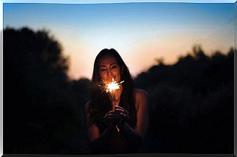 Woman walking with a light in her hands